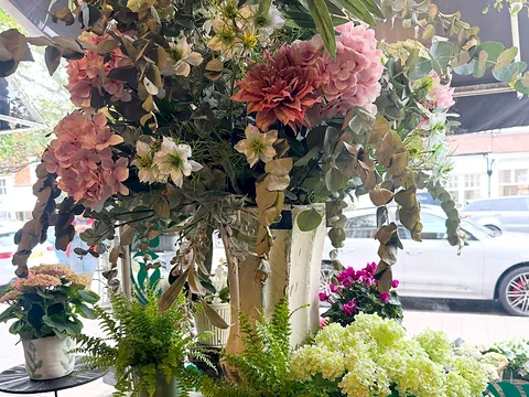 A big arrangement of flowers in the window at Moutan in Odiham