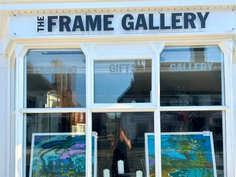 The Frame Gallery shopfront on Odiham High Street, with paintings in the windows