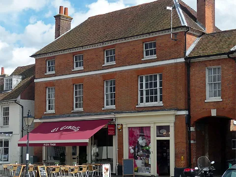 The tall Georgian building on Odiham High Street that is home to El Castello, with a red awning