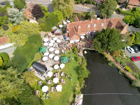 An aerial view of the Mill House in North Warnborough, with its garden of tables and parasols beside the millpond